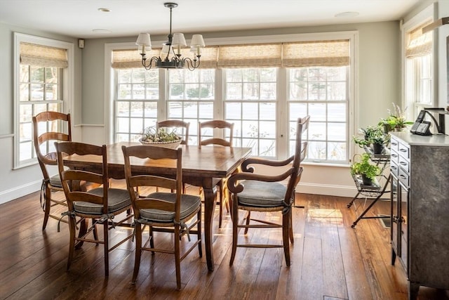 dining area featuring plenty of natural light, dark hardwood / wood-style floors, and a chandelier