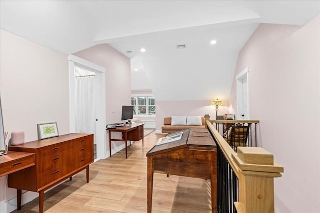 interior space featuring light hardwood / wood-style flooring and lofted ceiling