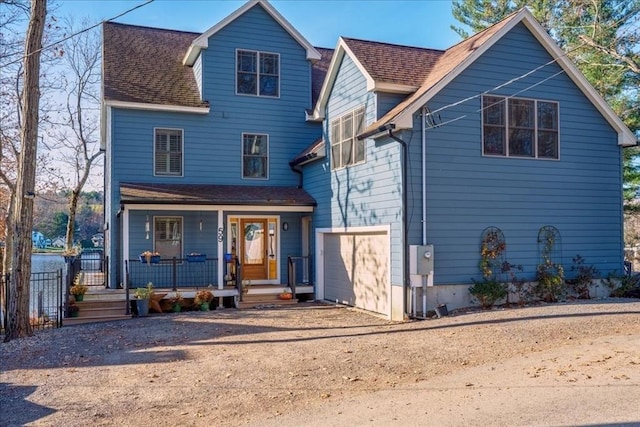 front of property featuring a porch and a garage