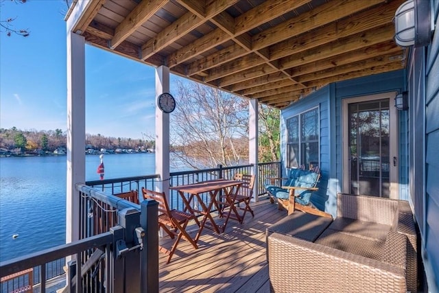 wooden deck featuring a water view