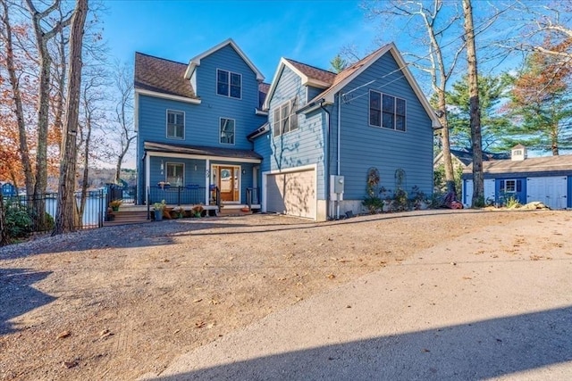 front of property with covered porch and a garage