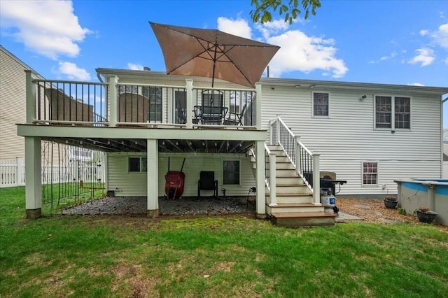back of property with a deck and stairway