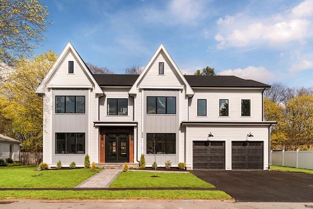 234 Valley Rd, Needham, MA 02492 - modern inspired farmhouse with board and batten siding, fence, aphalt driveway, french doors, and an attached garage