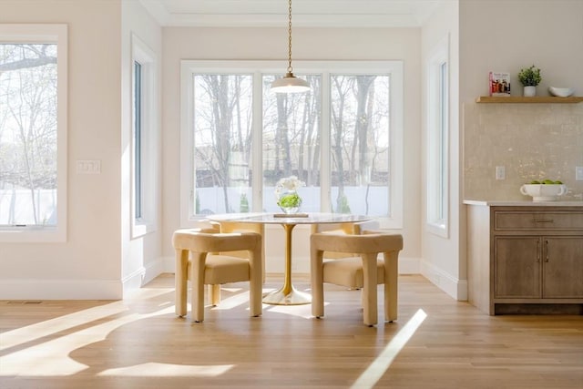 234 Valley Rd, Needham, MA 02492 - dining space featuring light wood-type flooring, crown molding, and baseboards
