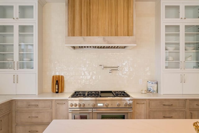 234 Valley Rd, Needham, MA 02492 - kitchen featuring premium range hood, backsplash, range with two ovens, and glass insert cabinets
