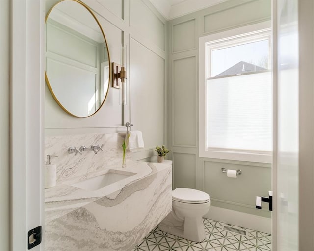 234 Valley Rd, Needham, MA 02492 - bathroom with a decorative wall, tile patterned floors, toilet, vanity, and visible vents