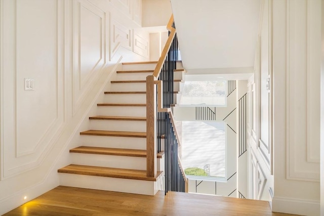 234 Valley Rd, Needham, MA 02492 - stairway featuring wood finished floors and a healthy amount of sunlight