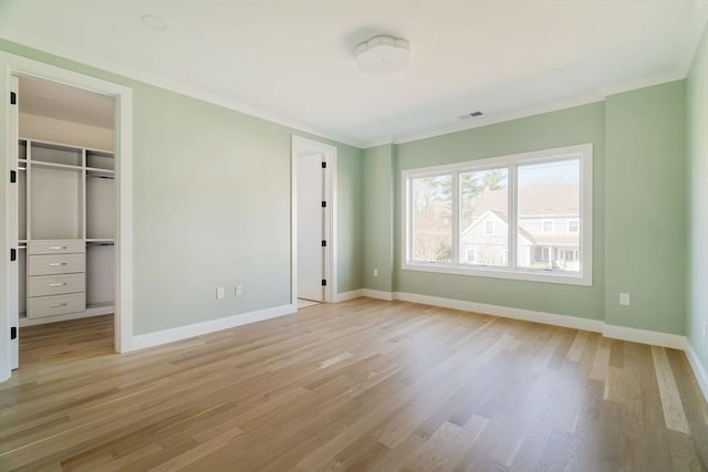 234 Valley Rd, Needham, MA 02492 - unfurnished bedroom with baseboards, ornamental molding, and light wood finished floors