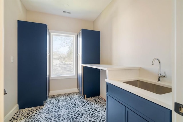 234 Valley Rd, Needham, MA 02492 - laundry area with visible vents, a sink, baseboards, and plenty of natural light