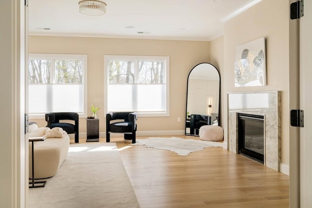 234 Valley Rd, Needham, MA 02492 - living room with baseboards, wood finished floors, a premium fireplace, and ornamental molding
