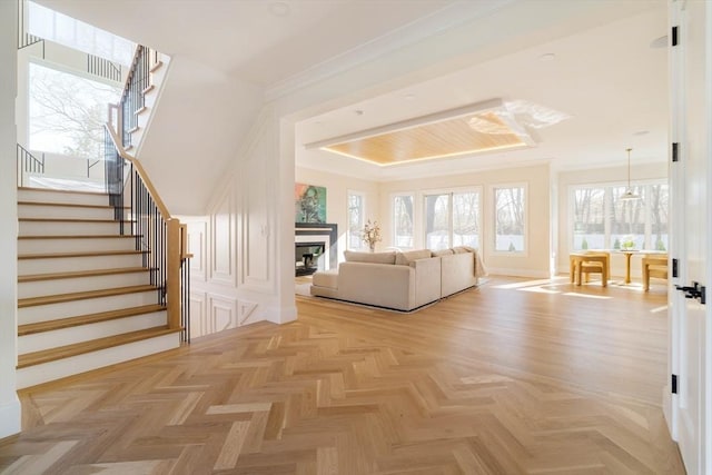 234 Valley Rd, Needham, MA 02492 - living area with ornamental molding, stairs, and a fireplace