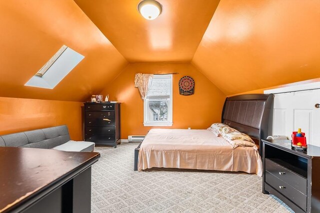 bedroom featuring carpet flooring, a baseboard radiator, and vaulted ceiling with skylight