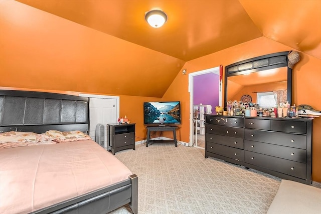 carpeted bedroom featuring lofted ceiling
