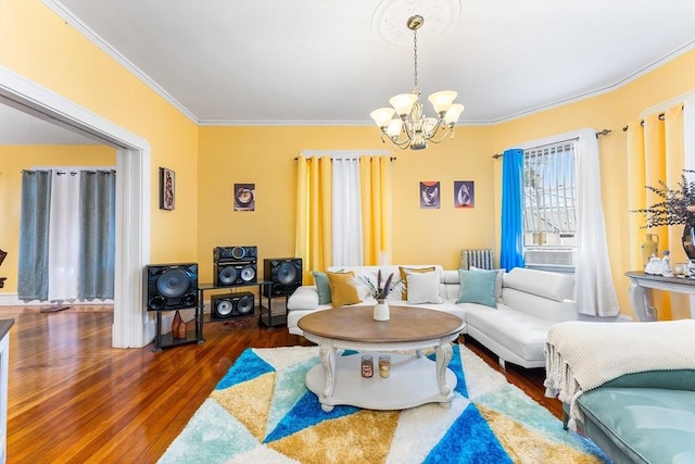 living room featuring wood finished floors, an inviting chandelier, and ornamental molding