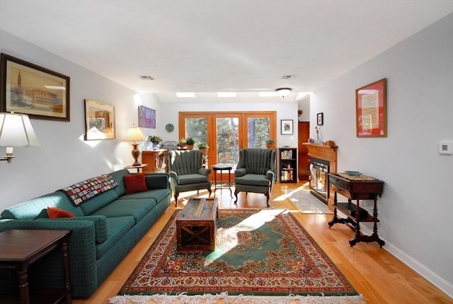 living room with light hardwood / wood-style floors and french doors