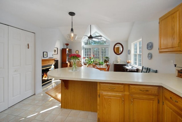 kitchen with pendant lighting, ceiling fan, kitchen peninsula, and light tile patterned floors