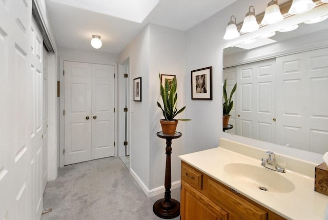 bathroom featuring a skylight and vanity