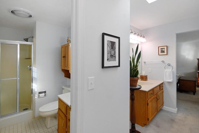 bathroom with an enclosed shower, vanity, and toilet