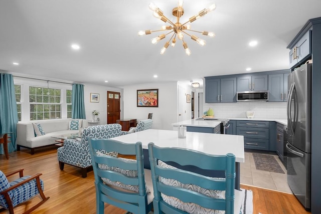interior space featuring light wood-type flooring, recessed lighting, and an inviting chandelier