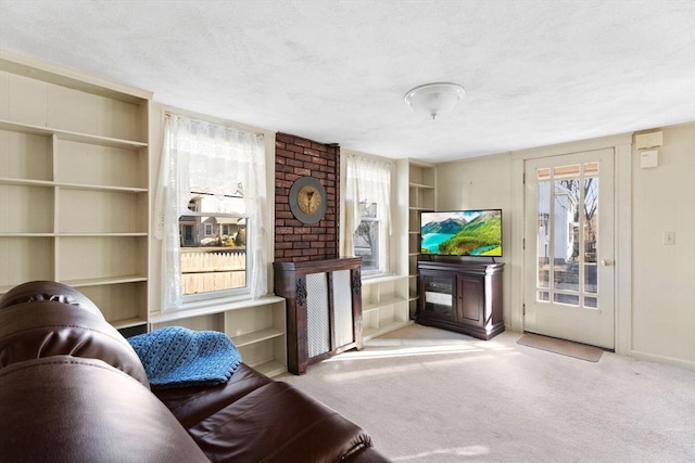 living room with carpet, a textured ceiling, and baseboards