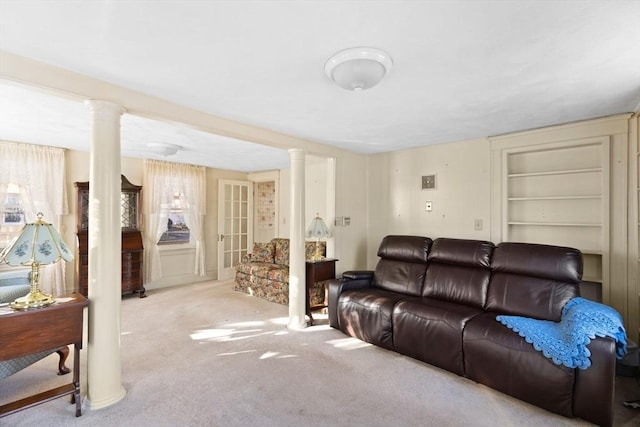 living area featuring carpet and ornate columns