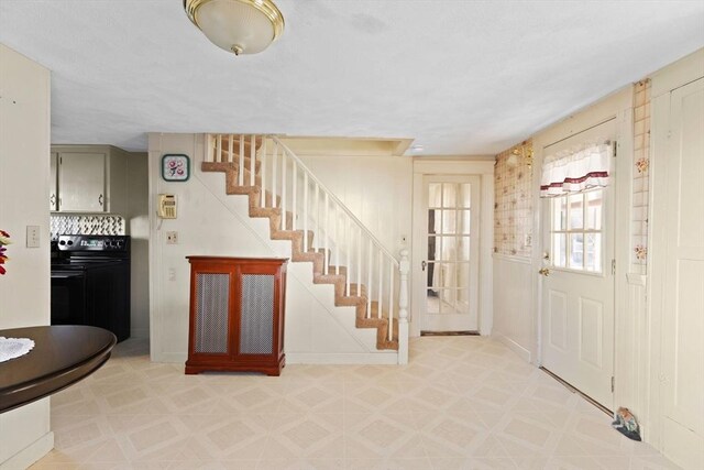 entryway with light floors and stairs