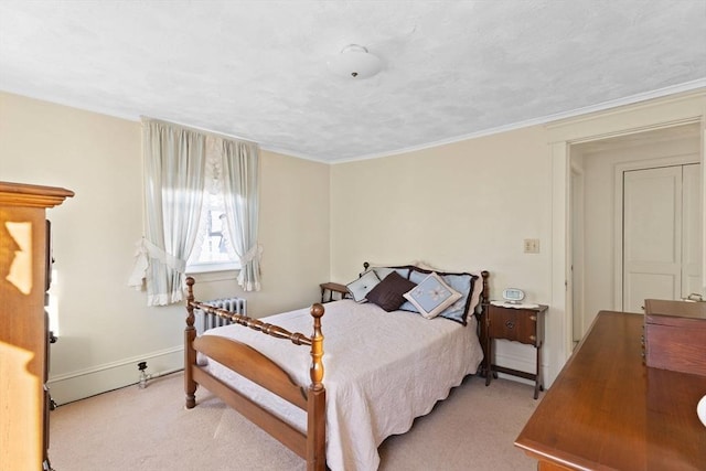 carpeted bedroom with radiator heating unit and baseboards