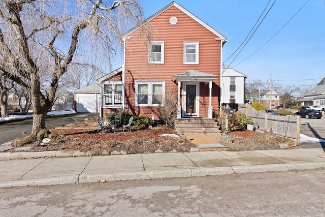 view of front of home with driveway and fence