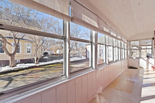 unfurnished sunroom featuring wooden ceiling and vaulted ceiling