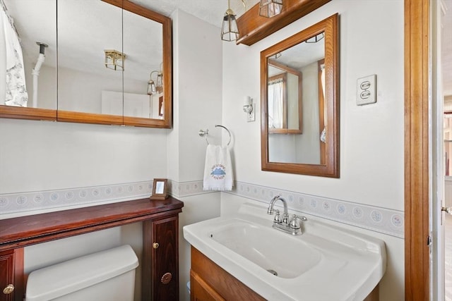 bathroom featuring vanity and toilet