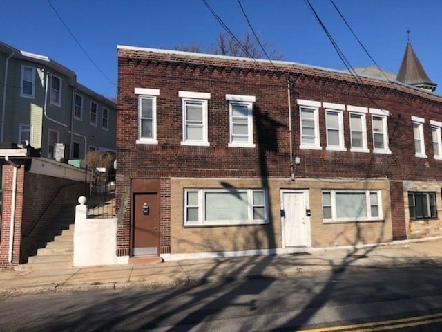 townhome / multi-family property featuring brick siding