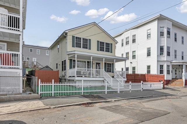 view of front of property featuring a fenced front yard and covered porch