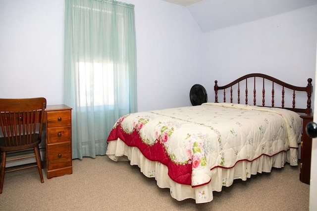 carpeted bedroom featuring lofted ceiling