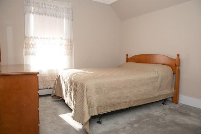 carpeted bedroom with multiple windows and vaulted ceiling