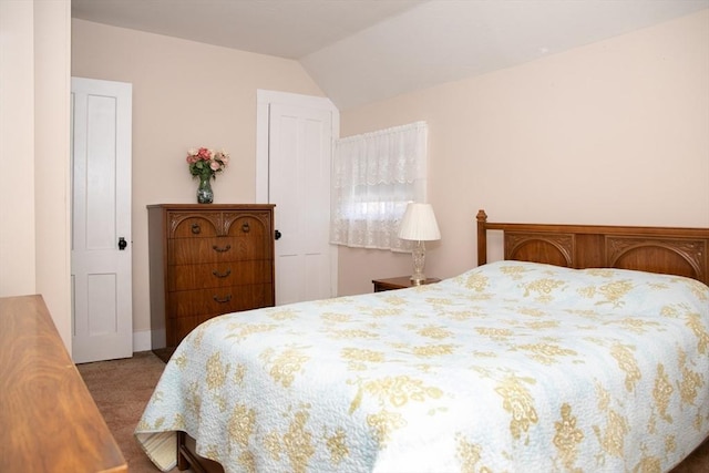 bedroom with vaulted ceiling and carpet flooring