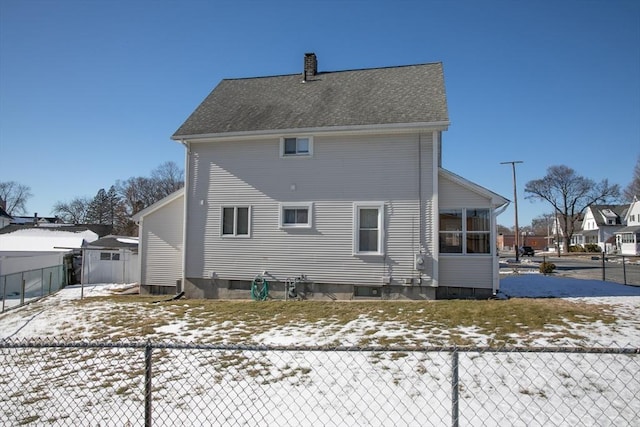 view of snow covered rear of property