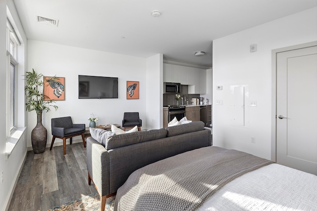 bedroom featuring sink and hardwood / wood-style flooring