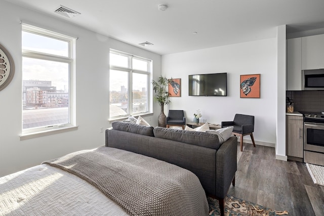 bedroom with dark hardwood / wood-style flooring