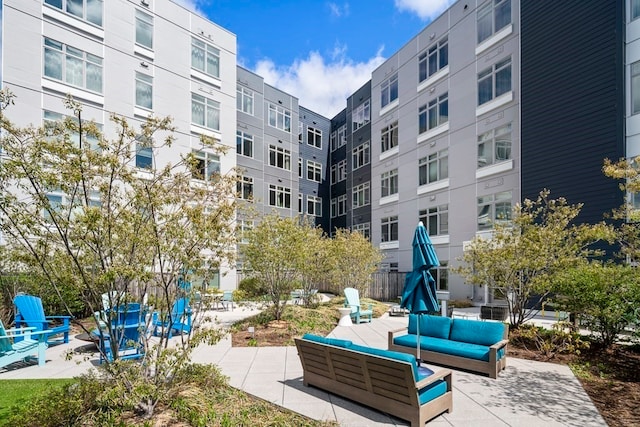 surrounding community featuring outdoor lounge area and a patio