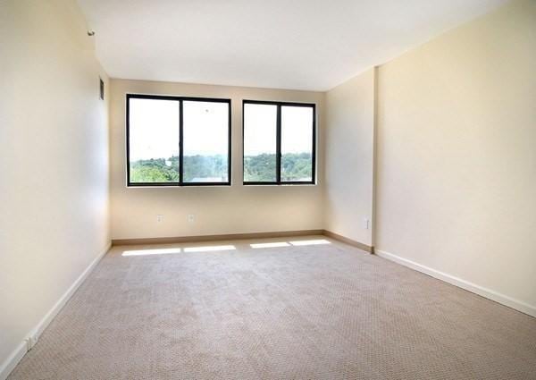 carpeted spare room featuring baseboards