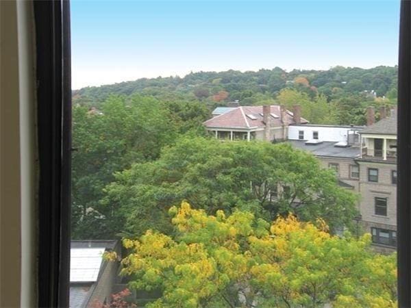 drone / aerial view with a wooded view