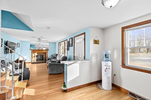 living room with light wood-type flooring and ceiling fan