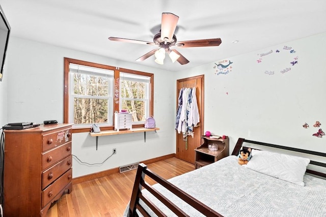 bedroom with ceiling fan and light hardwood / wood-style flooring