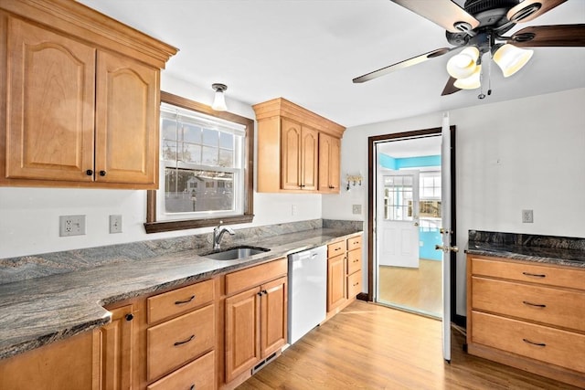 kitchen with a wealth of natural light, sink, dishwasher, and light hardwood / wood-style floors