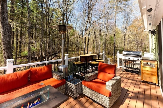deck featuring an outdoor hangout area and grilling area