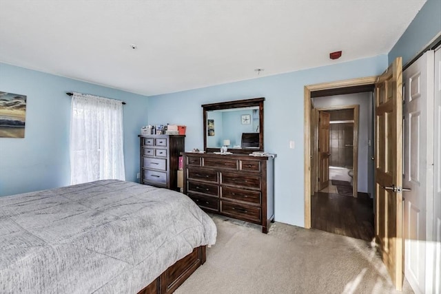 carpeted bedroom featuring connected bathroom