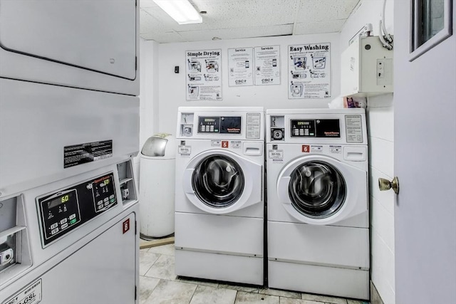 laundry room with washing machine and dryer and light tile patterned floors