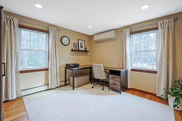 office space featuring recessed lighting, plenty of natural light, and a wall unit AC