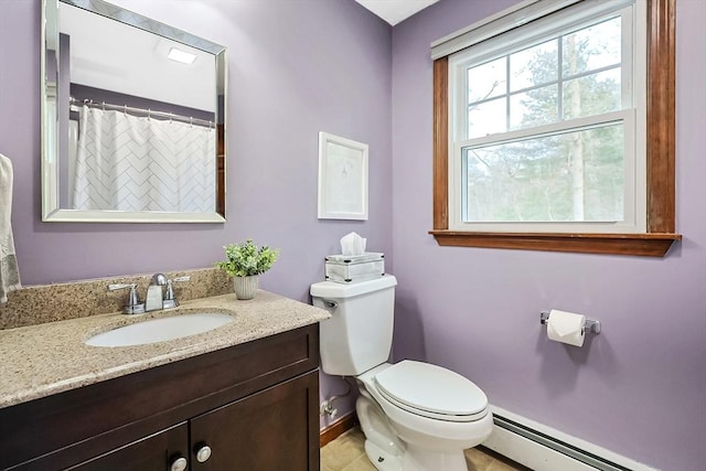 bathroom with a baseboard heating unit, toilet, vanity, and baseboards