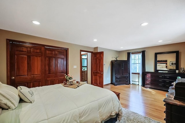 bedroom featuring recessed lighting, light wood-type flooring, and baseboard heating